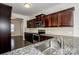 Modern kitchen with stainless steel appliances, granite countertops, and wood cabinetry at 140 Jana Dr, Statesville, NC 28677