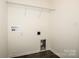 Functional laundry area with overhead shelving and essential hookups at 140 Jana Dr, Statesville, NC 28677