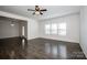 Open-concept living room with hardwood floors and large windows overlooking the neighborhood at 140 Jana Dr, Statesville, NC 28677