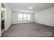 Spacious main bedroom with plush carpet and three sunny windows at 140 Jana Dr, Statesville, NC 28677