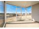 A spacious screened in porch with a view of the landscaped backyard and neighboring houses at 140 Jana Dr, Statesville, NC 28677