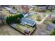 Aerial view of the property showing the house, yard, firepit, shed, and surrounding neighborhood at 1818 Valley Springs Se Dr, Conover, NC 28613