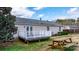 Backyard showcasing a picnic table, back deck, and lush landscaping with mature trees at 1818 Valley Springs Se Dr, Conover, NC 28613