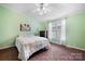 Bright bedroom featuring a large window, ceiling fan, and classic furnishings at 1818 Valley Springs Se Dr, Conover, NC 28613