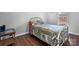 Cozy bedroom featuring hardwood floors, a brass bed frame and colorful, patterned bedspread at 1818 Valley Springs Se Dr, Conover, NC 28613