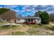 Charming home featuring a quaint front porch, stone accents, and a well-maintained lawn at 1818 Valley Springs Se Dr, Conover, NC 28613