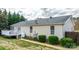 Exterior of a home featuring a back deck with white railings, and landscaped shrubs at 1818 Valley Springs Se Dr, Conover, NC 28613