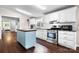 Bright kitchen with white cabinets, stainless steel appliances, and a blue center island at 1818 Valley Springs Se Dr, Conover, NC 28613