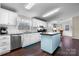Bright, open kitchen features stainless appliances, center island, and adjacent dining area at 1818 Valley Springs Se Dr, Conover, NC 28613