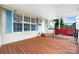 Cozy, covered porch area, featuring a wooden deck and comfortable porch swing at 1818 Valley Springs Se Dr, Conover, NC 28613