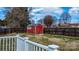 A wooden shed is situated in a fenced backyard behind a deck with white railings at 1818 Valley Springs Se Dr, Conover, NC 28613