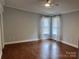 Inviting bedroom with hardwood floors, natural light, neutral walls, and a ceiling fan at 2321 Lakeview Cir, Matthews, NC 28105