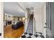 Inviting entryway featuring a staircase, hardwood floors, and views into the cozy living room at 305 Wagner St, Troutman, NC 28166