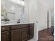 Bathroom featuring a dark vanity, countertop, decorative flower and access to other rooms at 3078 Montreaux Valley Dr, Fort Mill, SC 29707