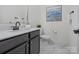 Neutral powder bath with marble floor and counter and modern fixtures at 3078 Montreaux Valley Dr, Fort Mill, SC 29707
