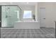 Bathroom showcases large tub, tiled shower, and unique patterned tile flooring at 3078 Montreaux Valley Dr, Fort Mill, SC 29707