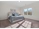 Bright bedroom featuring hardwood flooring, a comfortable bed, and a large window with natural light at 3078 Montreaux Valley Dr, Fort Mill, SC 29707