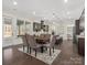 Open dining room with wood floors and a view of the kitchen and outdoors at 3078 Montreaux Valley Dr, Fort Mill, SC 29707
