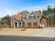 Traditional brick home featuring a manicured lawn, attached garage, and classic architectural details at 3078 Montreaux Valley Dr, Fort Mill, SC 29707
