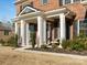 Inviting front porch with stately columns, seating, and professionally landscaped surroundings at 3078 Montreaux Valley Dr, Fort Mill, SC 29707