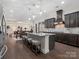 Open concept kitchen with granite counters, barstool seating, and stainless fixtures at 3078 Montreaux Valley Dr, Fort Mill, SC 29707
