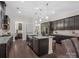 Modern kitchen island with stainless steel sink and stylish pendant lighting at 3078 Montreaux Valley Dr, Fort Mill, SC 29707