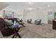 Cozy living room with soft carpeting, comfortable seating, and ample natural light from large windows at 3078 Montreaux Valley Dr, Fort Mill, SC 29707