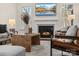 Cozy living room with fireplace, large TV, and comfortable leather seating at 3078 Montreaux Valley Dr, Fort Mill, SC 29707