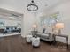 Cozy sitting room with dark hardwood floors, sofa, and view to main bedroom at 3078 Montreaux Valley Dr, Fort Mill, SC 29707