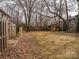 Large, private backyard bordered by mature trees and wooden fence at 3170 Heathstead Pl, Charlotte, NC 28210