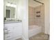 Bright bathroom with granite countertop vanity and tiled shower with tub at 3170 Heathstead Pl, Charlotte, NC 28210
