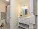 Charming bathroom with white vanity, decorative mirror, and tiled shower at 3170 Heathstead Pl, Charlotte, NC 28210