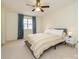 Cozy bedroom featuring a ceiling fan, plush carpet, and a bright window at 3170 Heathstead Pl, Charlotte, NC 28210