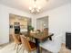 Dining room with wood table, modern chandelier, and open view to kitchen at 3170 Heathstead Pl, Charlotte, NC 28210