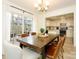 Bright dining room with modern chandelier, patio access and stainless appliances at 3170 Heathstead Pl, Charlotte, NC 28210