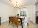 Dining room with modern chandelier, wood table, and patio doors for natural light at 3170 Heathstead Pl, Charlotte, NC 28210