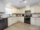 Updated kitchen features white cabinets, stainless steel appliances, and stylish countertops at 3170 Heathstead Pl, Charlotte, NC 28210