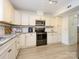 Well-lit kitchen with stainless steel appliances and ample cabinet space at 3170 Heathstead Pl, Charlotte, NC 28210