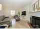 Bright living room with fireplace, large windows, and modern decor at 3170 Heathstead Pl, Charlotte, NC 28210