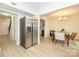Open living space with a fireplace, stainless refrigerator and adjacent dining area at 3170 Heathstead Pl, Charlotte, NC 28210