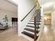 Staircase with dark wood treads and decorative wrought iron railing at 3170 Heathstead Pl, Charlotte, NC 28210