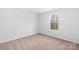 Bedroom with a window letting in natural light and neutral colored carpet at 3267 Maple Ridge Dr, Gastonia, NC 28052