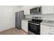 Updated kitchen with stainless steel appliances, granite countertops, white cabinetry, and ample natural light at 3267 Maple Ridge Dr, Gastonia, NC 28052