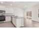 Modern kitchen featuring white cabinetry, stainless steel appliances, and a breakfast bar with granite countertops at 3267 Maple Ridge Dr, Gastonia, NC 28052
