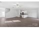 Spacious living room with hardwood floors and neutral decor that seamlessly flows into a modern kitchen at 3267 Maple Ridge Dr, Gastonia, NC 28052