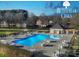 Community pool and lounge area with tables and chairs and nearby pool house at 3427 Laurel Oak Ln, Gastonia, NC 28056