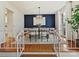 Stylish dining room with a modern chandelier, navy accent wall, and seating for six at 4132 Sulkirk Rd, Charlotte, NC 28210