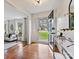 Welcoming foyer featuring hardwood floors, glass front door and sidelights and an adjacent living space at 4132 Sulkirk Rd, Charlotte, NC 28210