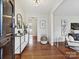 Bright entryway featuring hardwood floors, a console table, and a view into the rest of the home at 4132 Sulkirk Rd, Charlotte, NC 28210