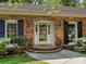 Close-up of the front entrance showcasing brick steps and a glass front door with black window shutters at 4132 Sulkirk Rd, Charlotte, NC 28210